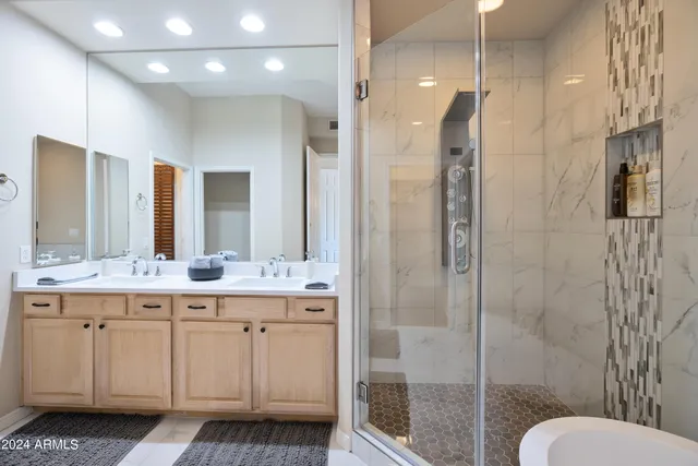 a bathroom with a double vanity sink toilet and shower