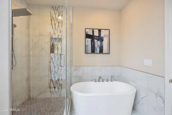 a white bath tub sitting next to a white sink