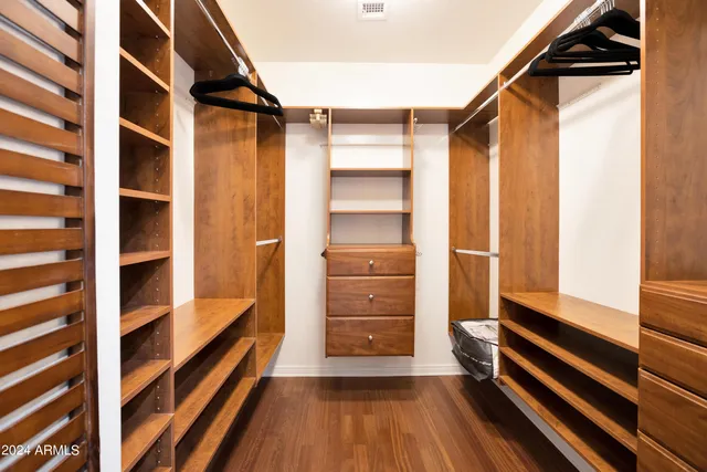 a view of walk in closet with empty racks