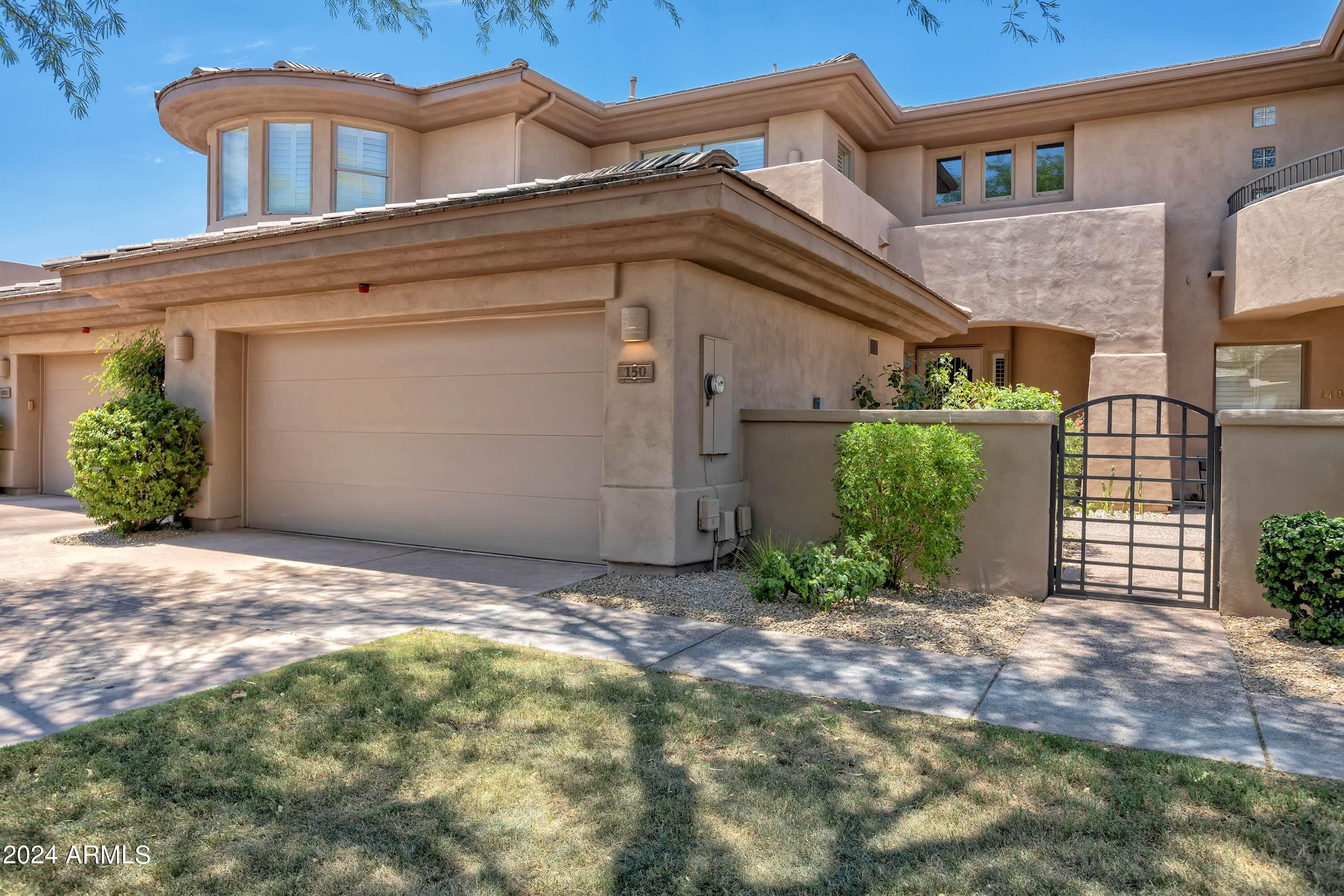 15240 North Clubgate Drive, Unit 150 Scottsdale, AZ 85254 - Photo 2 of 42 a view of a house with a small yard and plants