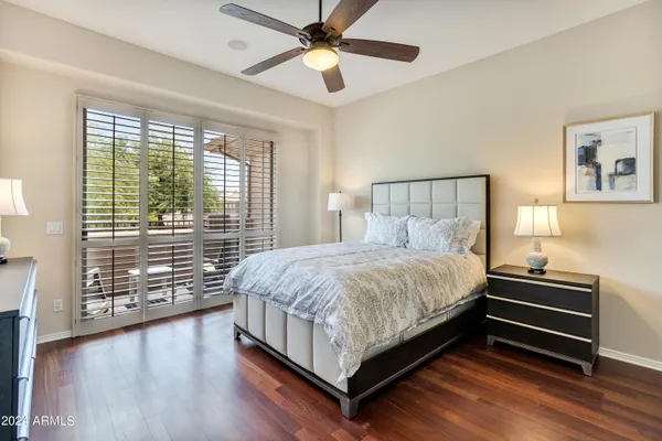 a bed sitting in a spacious bedroom next to a window