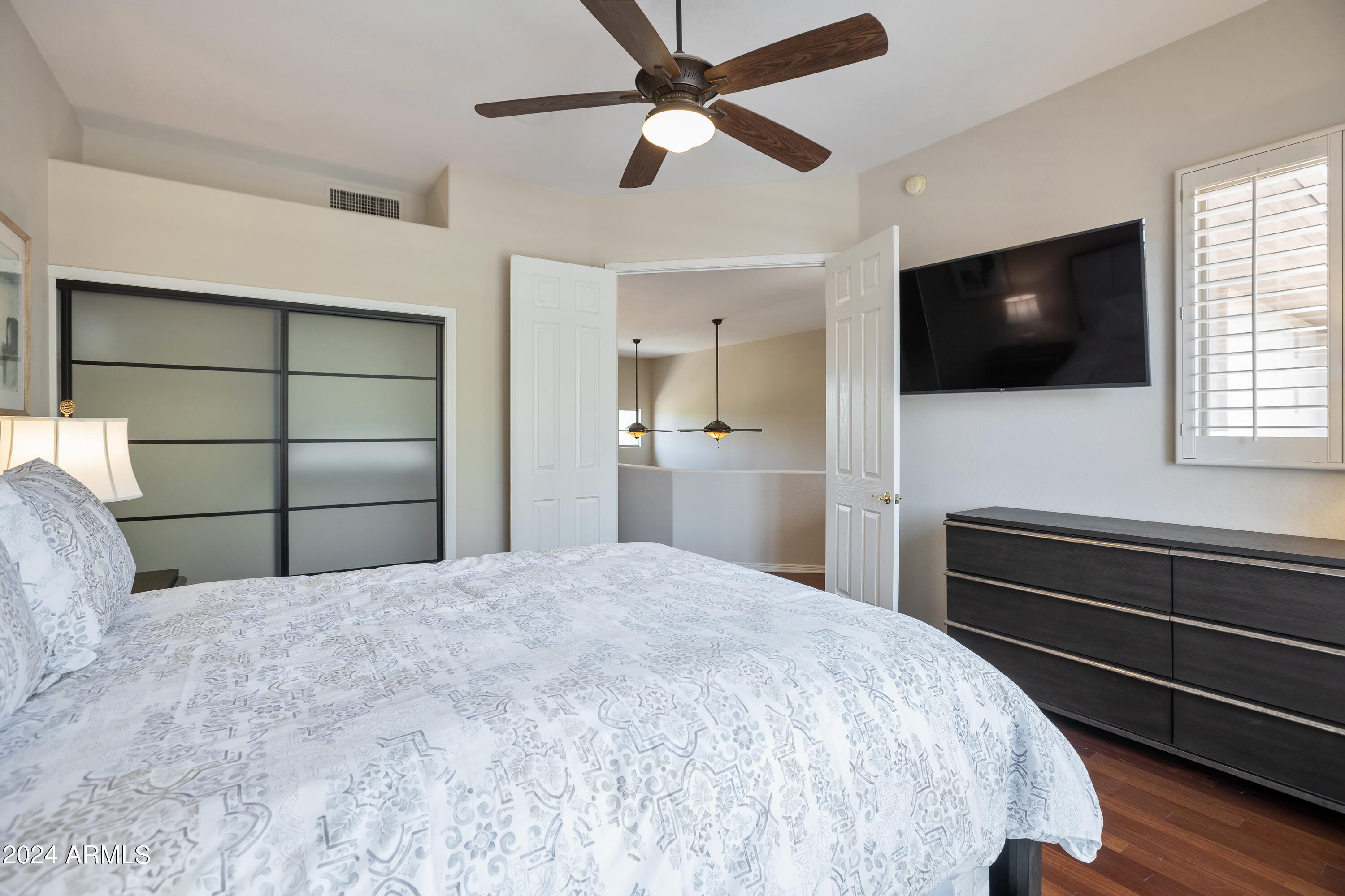 15240 North Clubgate Drive, Unit 150 Scottsdale, AZ 85254 - Photo 23 of 42 a bedroom with a bed and a flat screen tv