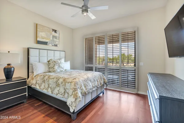 a bedroom with a bed and flat screen tv