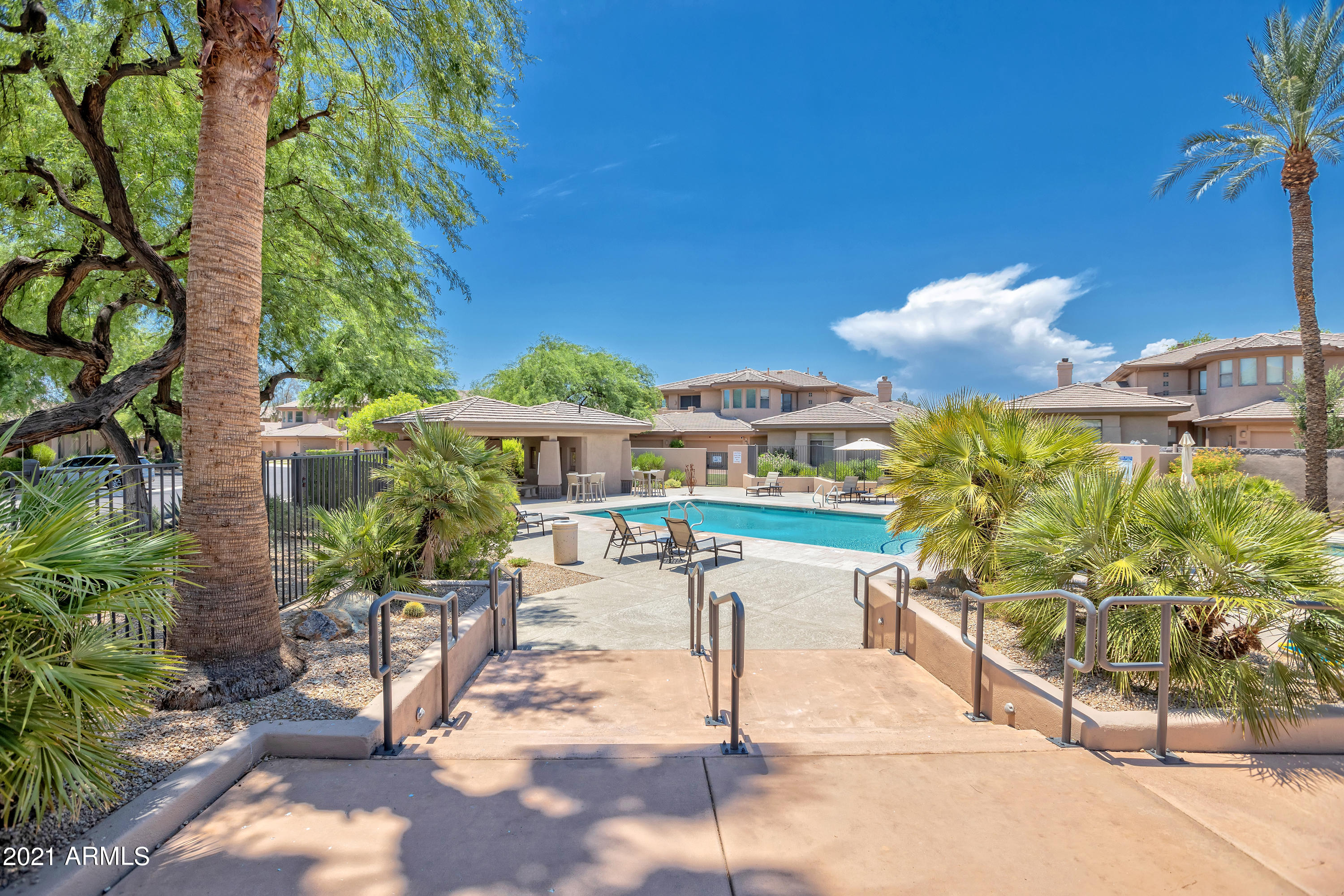 15240 North Clubgate Drive, Unit 150 Scottsdale, AZ 85254 - Photo 33 of 42 a view of a porch with chairs and potted plants