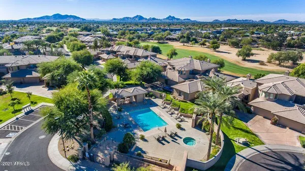 a view of a swimming pool with a patio and a garden