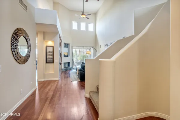 a view of entryway and hall with wooden floor