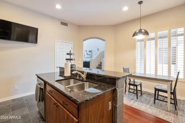 a kitchen with a sink a counter space and dining table
