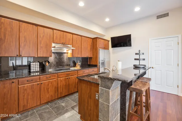 a kitchen with stainless steel appliances granite countertop a sink and cabinets