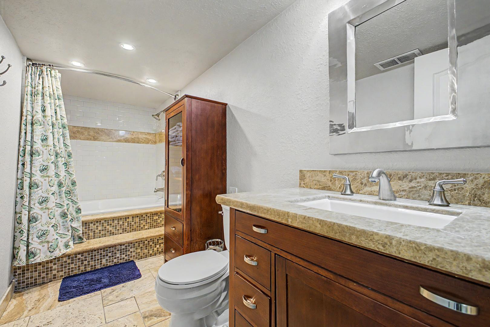 3346 East Cochise Road Phoenix, AZ 85028 - Photo 27 of 40 a bathroom with a granite countertop sink toilet and shower
