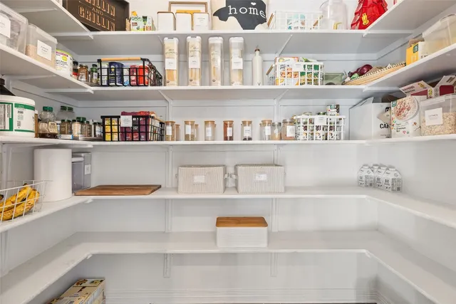 a cabinet with white cabinets and a wooden floor