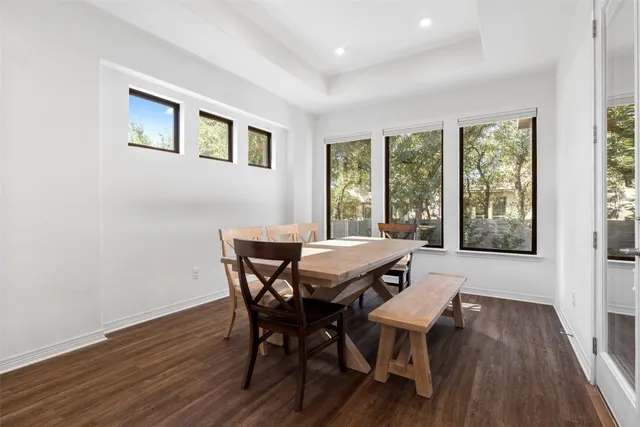 a view of a dining room with furniture and wooden floor