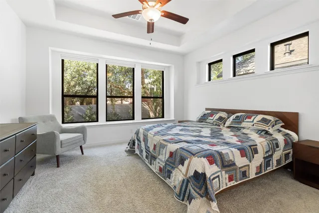 a bedroom with a bed chair and window