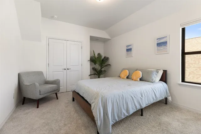 a bedroom with a bed and a couch