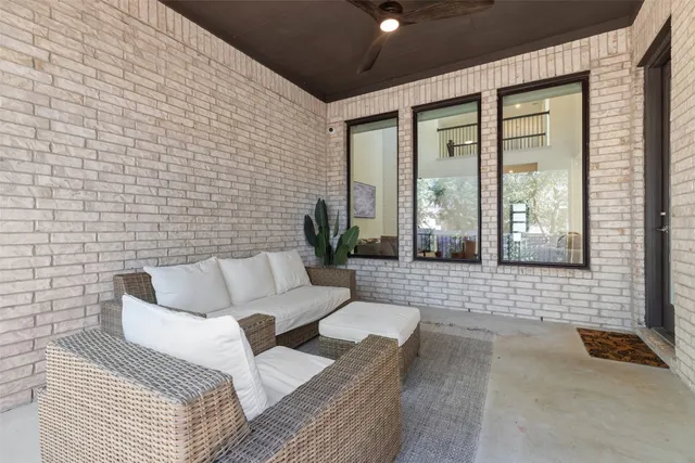 a view of a patio with couches and potted plant