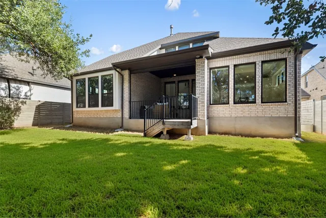 a view of a house with a yard and sitting area