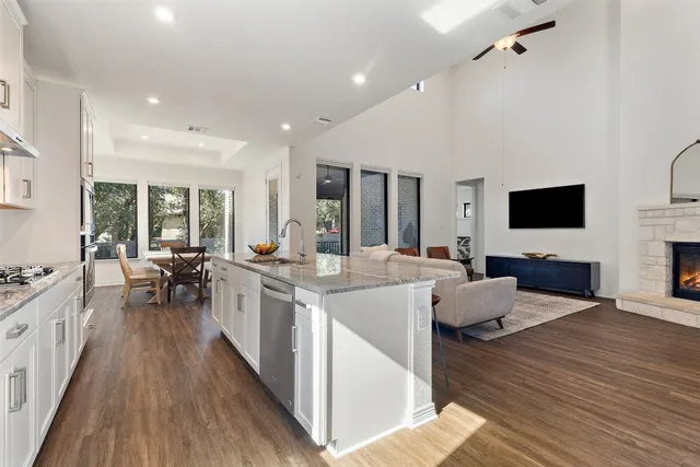 a large open kitchen with a large window and stainless steel appliances