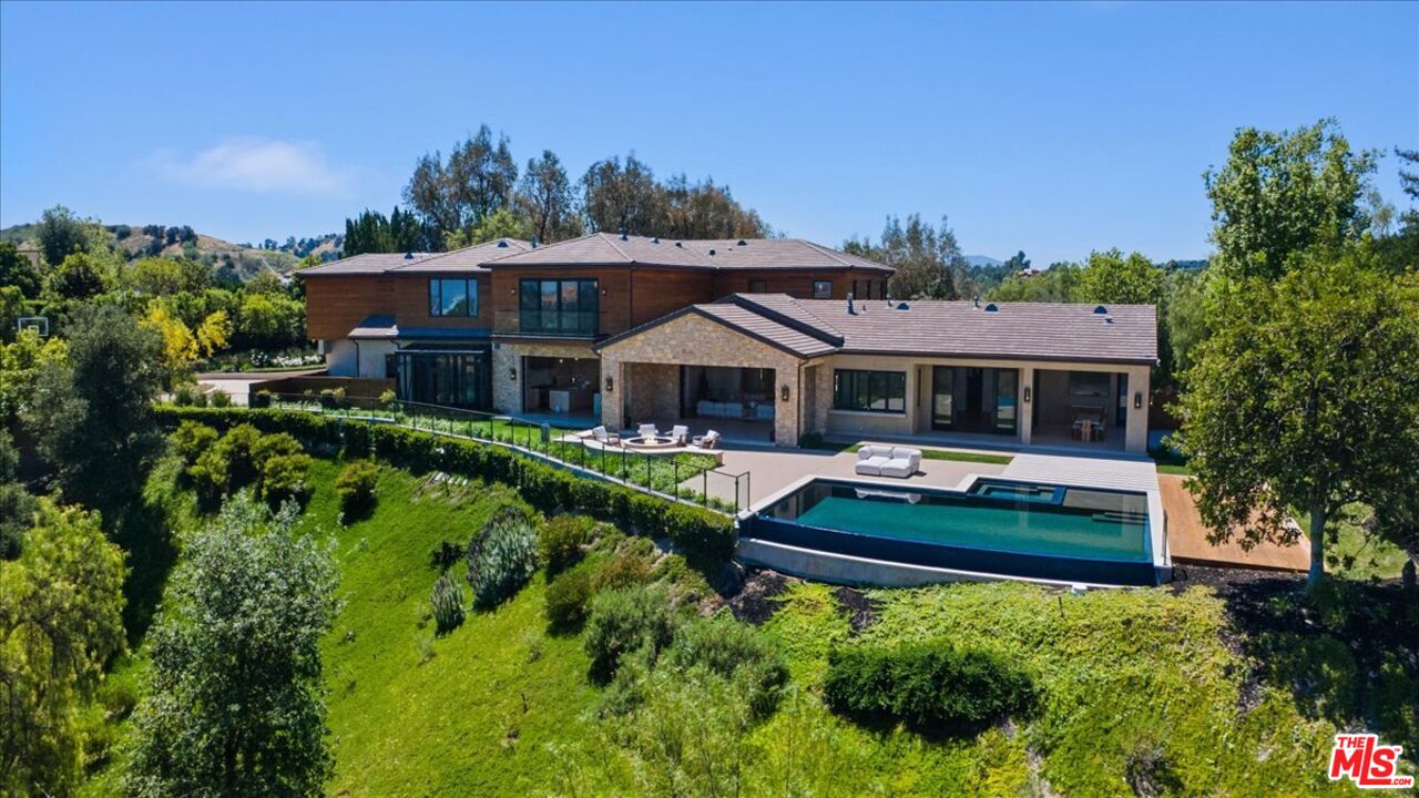 a view of house with yard entertaining space and outdoor seating