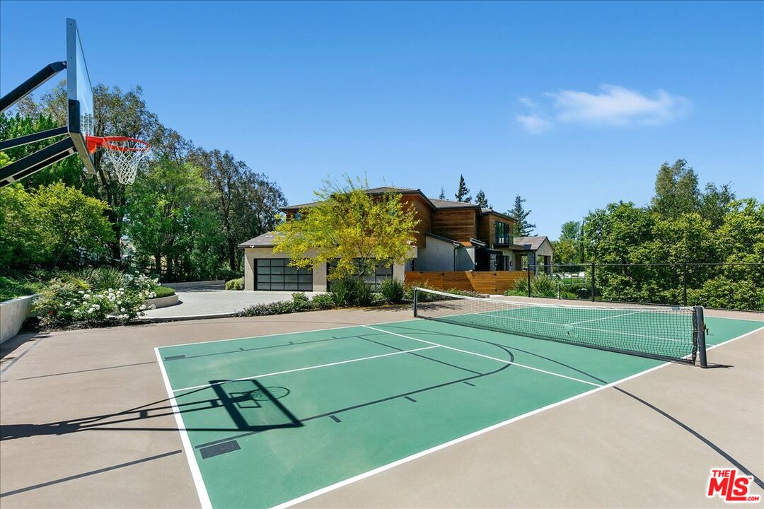 5757 Hoback Glen Road Hidden Hills, CA 91302 - Photo 11 of 41 a view of a tennis ground with large trees