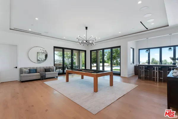 a living room with furniture a window and a chandelier