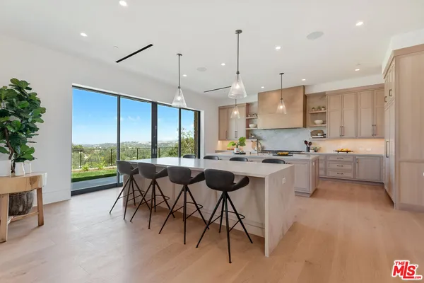 a open dining room with stainless steel appliances granite countertop a stove and a refrigerator