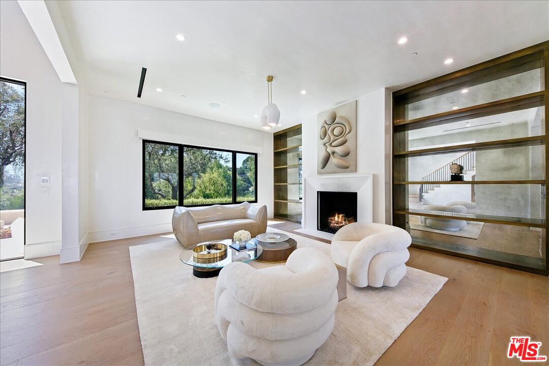 5757 Hoback Glen Road Hidden Hills, CA 91302 - Photo 16 of 41 a living room with furniture and a fireplace