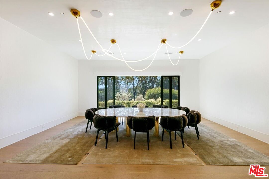 5757 Hoback Glen Road Hidden Hills, CA 91302 - Photo 17 of 41 a dining room with furniture and wooden floor