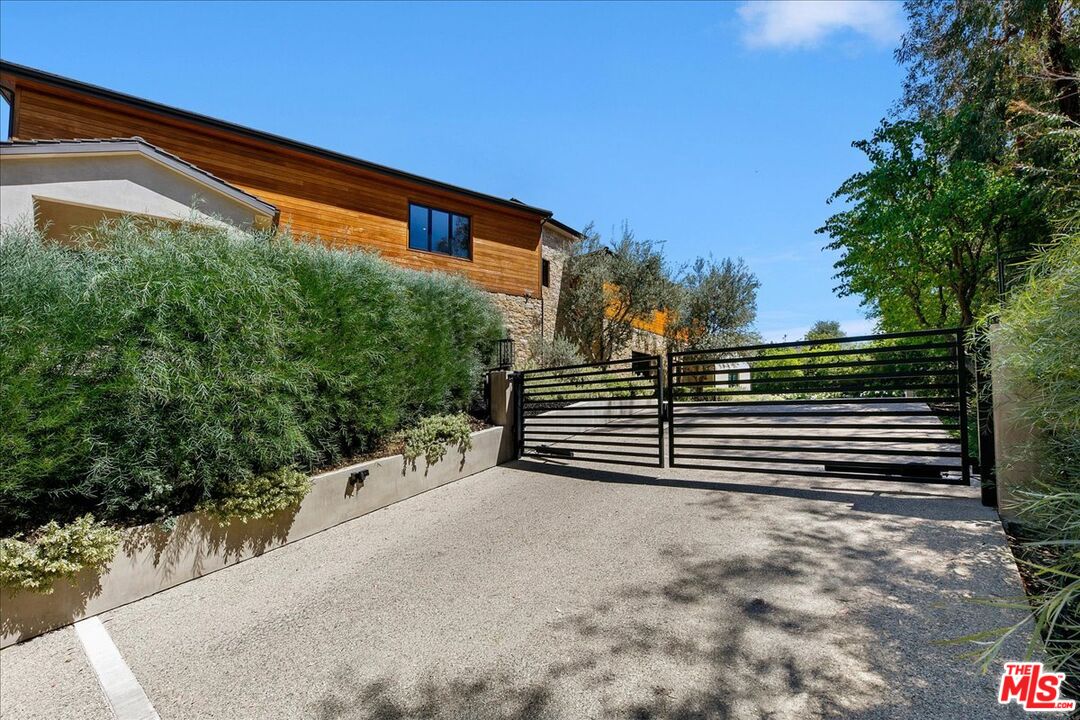 5757 Hoback Glen Road Hidden Hills, CA 91302 - Photo 2 of 41 a view of street with stairs and wooden fence