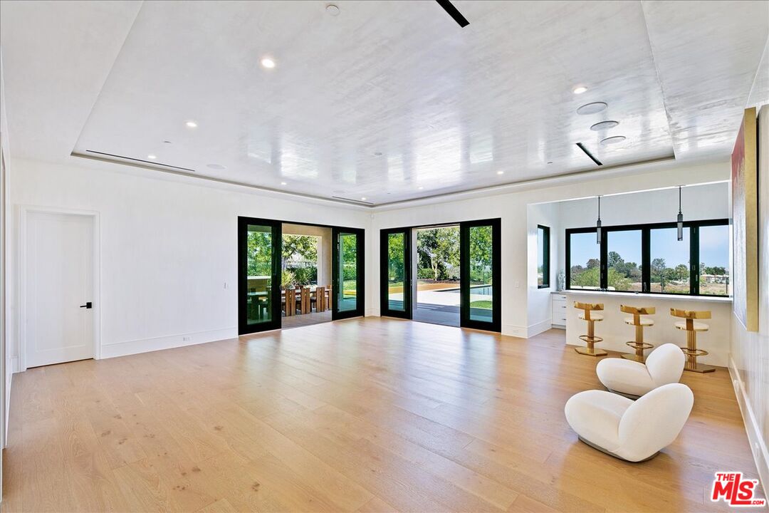 5757 Hoback Glen Road Hidden Hills, CA 91302 - Photo 21 of 41 a large living room with furniture and a large window