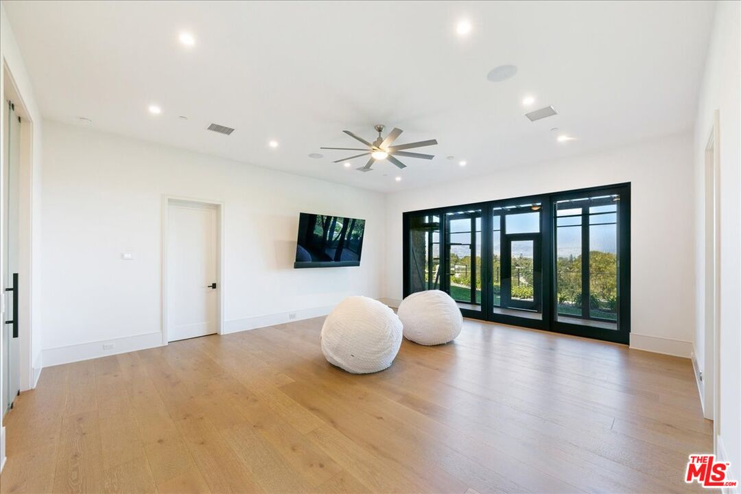 5757 Hoback Glen Road Hidden Hills, CA 91302 - Photo 22 of 41 a view of a livingroom with a large window and wooden floor