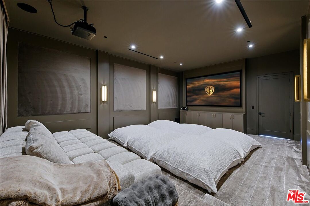 5757 Hoback Glen Road Hidden Hills, CA 91302 - Photo 25 of 41 a bedroom with a large bed and a flat tv screen