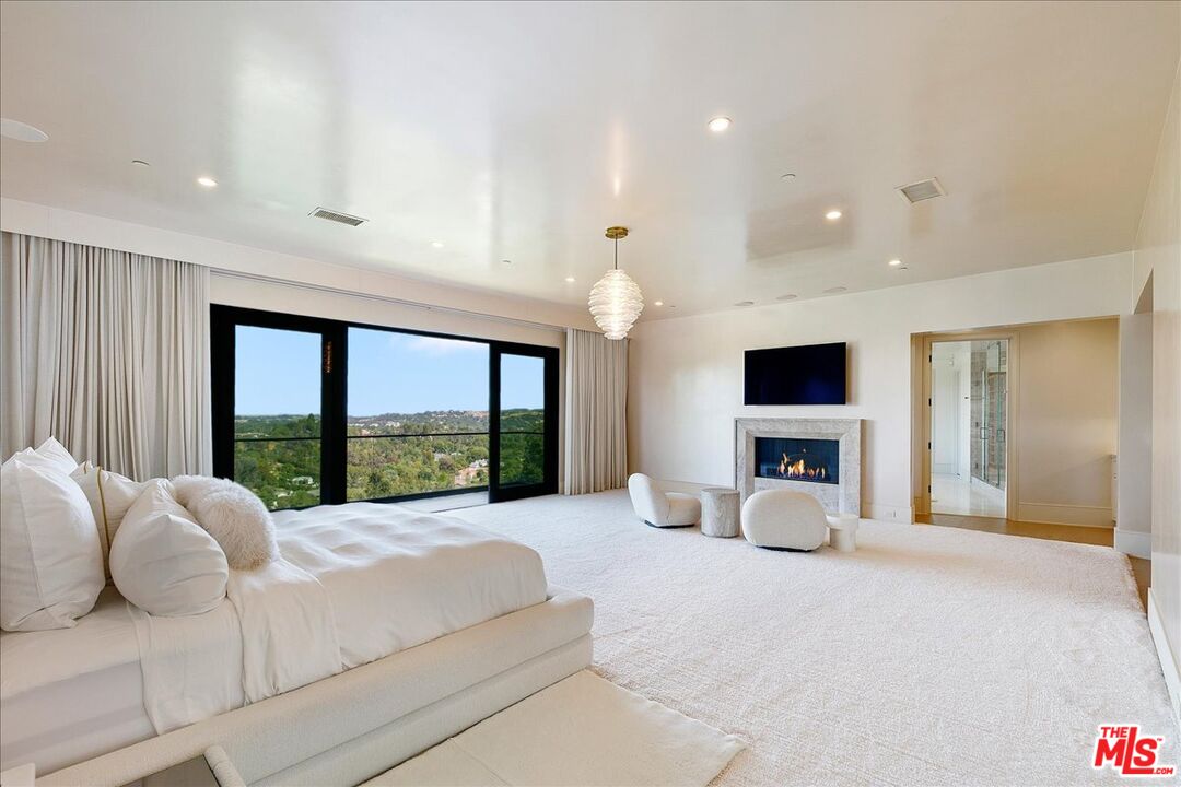 5757 Hoback Glen Road Hidden Hills, CA 91302 - Photo 27 of 41 a large bedroom with a large bed and a large window