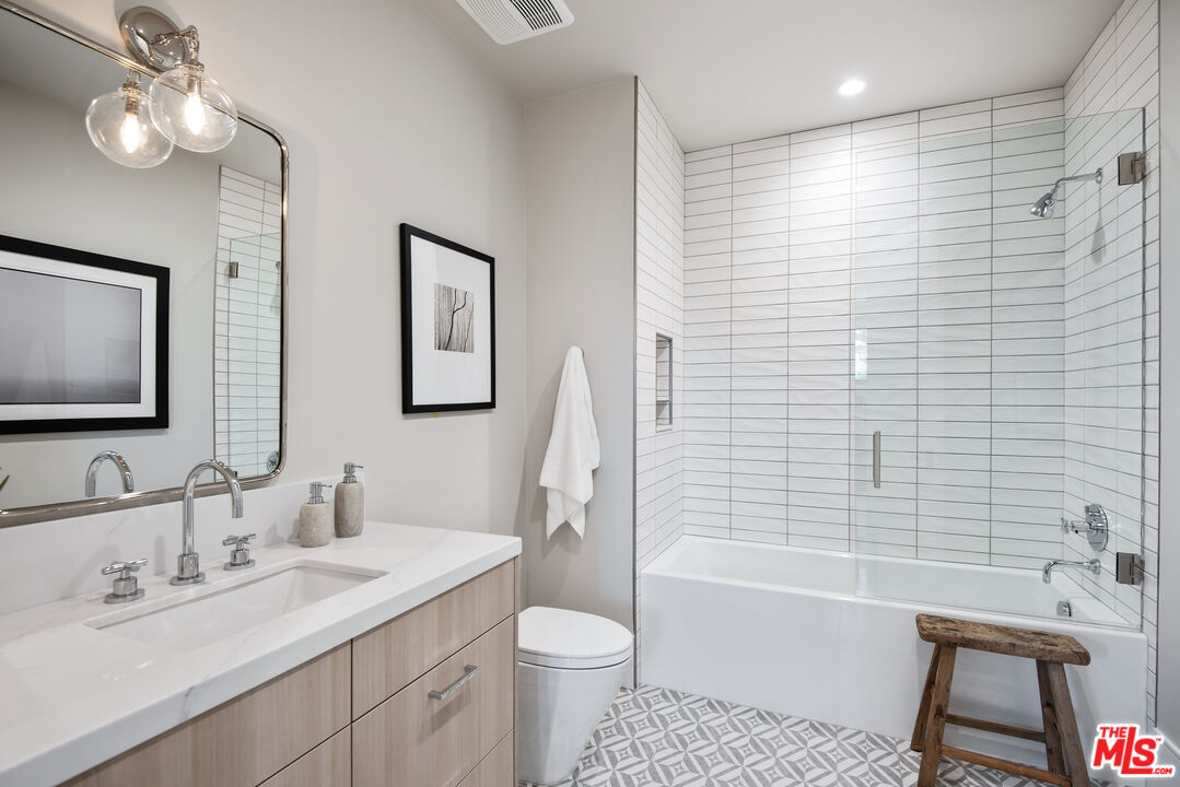 5757 Hoback Glen Road Hidden Hills, CA 91302 - Photo 34 of 41 a bathroom with a toilet a sink a tub and mirror