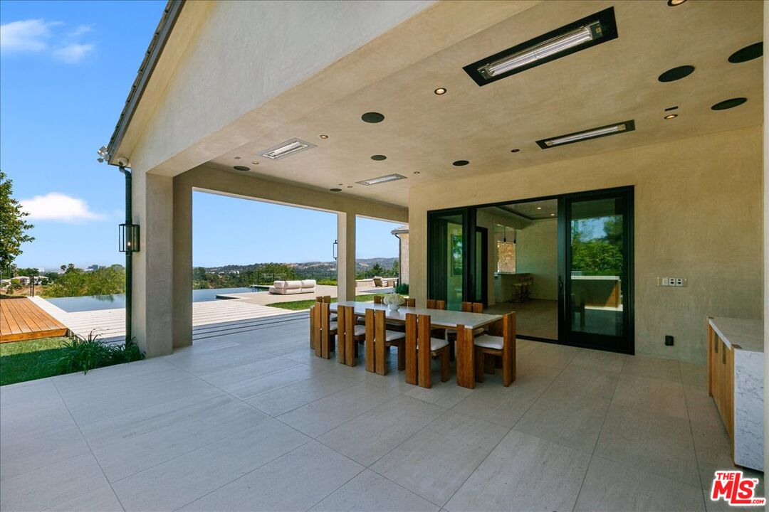 5757 Hoback Glen Road Hidden Hills, CA 91302 - Photo 8 of 41 a view of a patio with a dining table and chairs