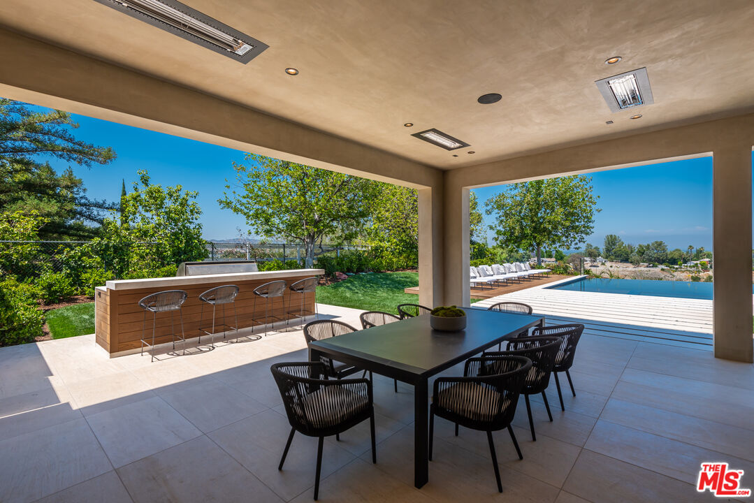 5757 Hoback Glen Road Hidden Hills, CA 91302 - Photo 9 of 41 a view of a patio with a table and chairs