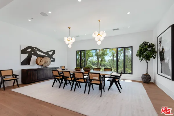 a dining room with furniture a chandelier and a rug
