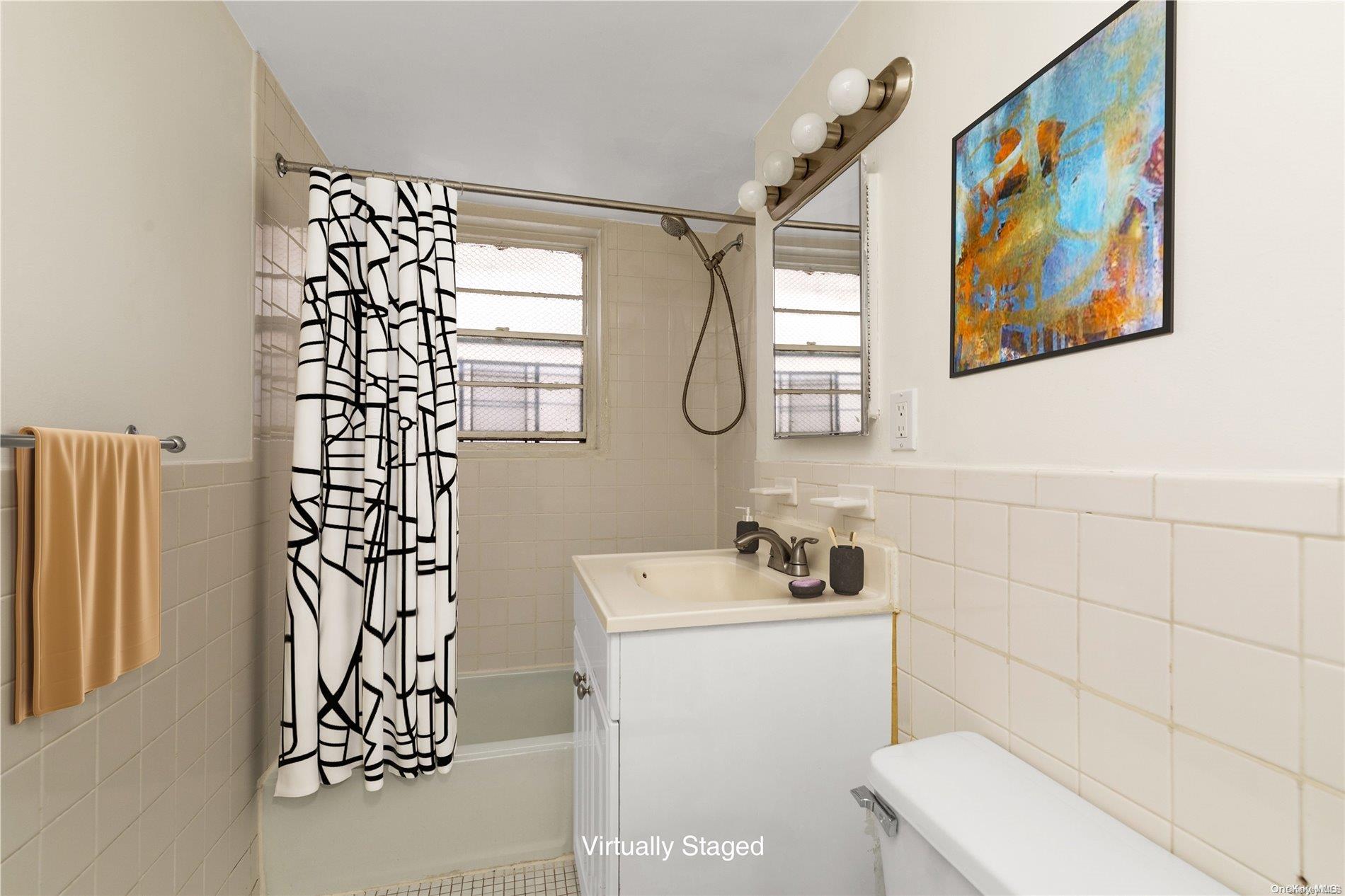 109-33 71st Road, Unit 7B Queens, NY 11375 - Photo 13 of 14 a bathroom with a sink a toilet and shower curtain