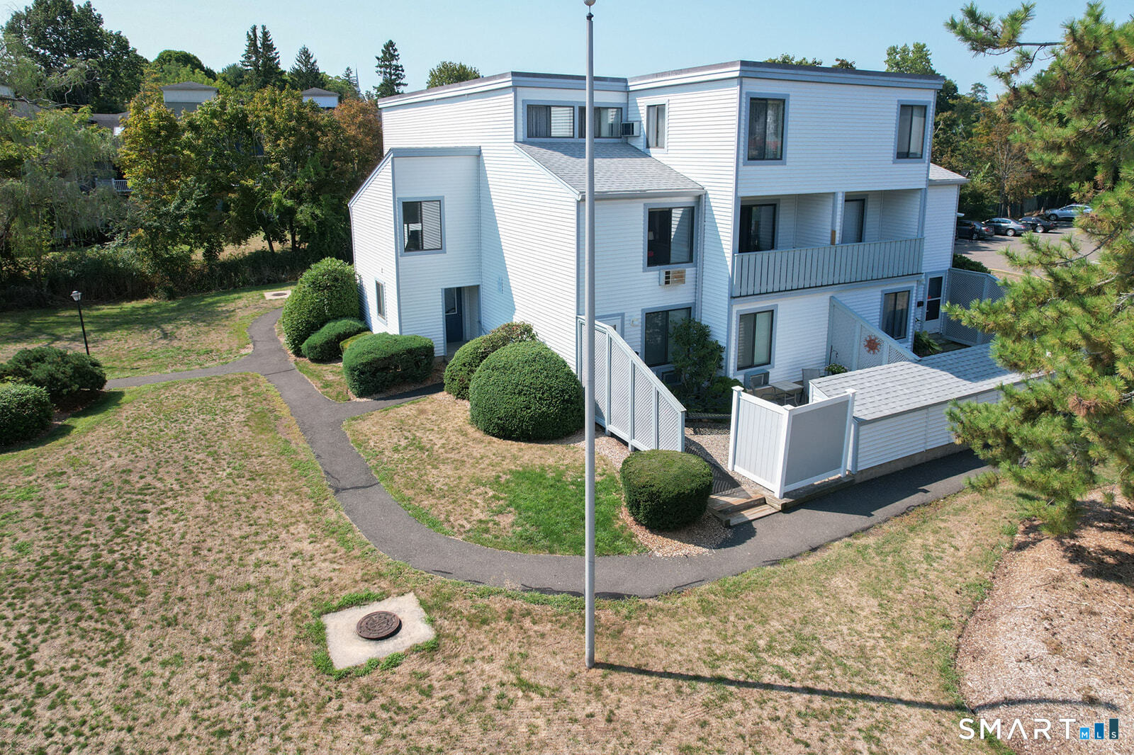 2 Hamre Lane, Unit D Branford, CT 06405 - Photo 1 of 18 a view of a white house with a yard and potted plants