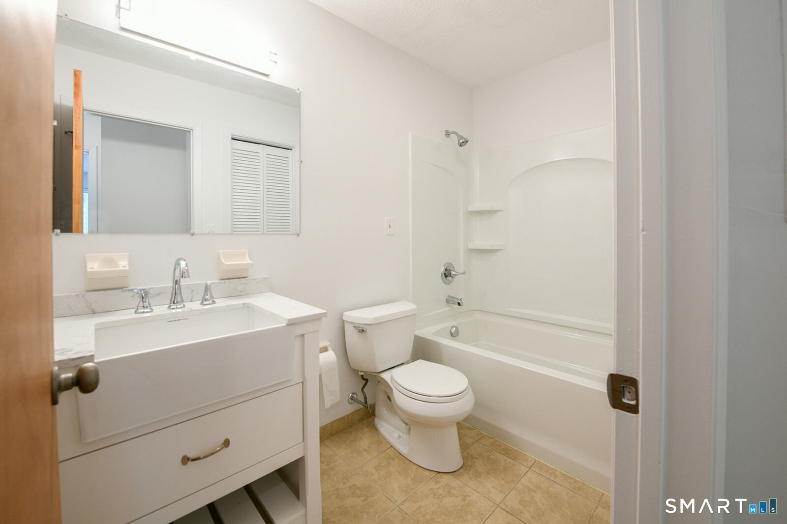 2 Hamre Lane, Unit D Branford, CT 06405 - Photo 16 of 18 a bathroom with a sink toilet vanity and shower