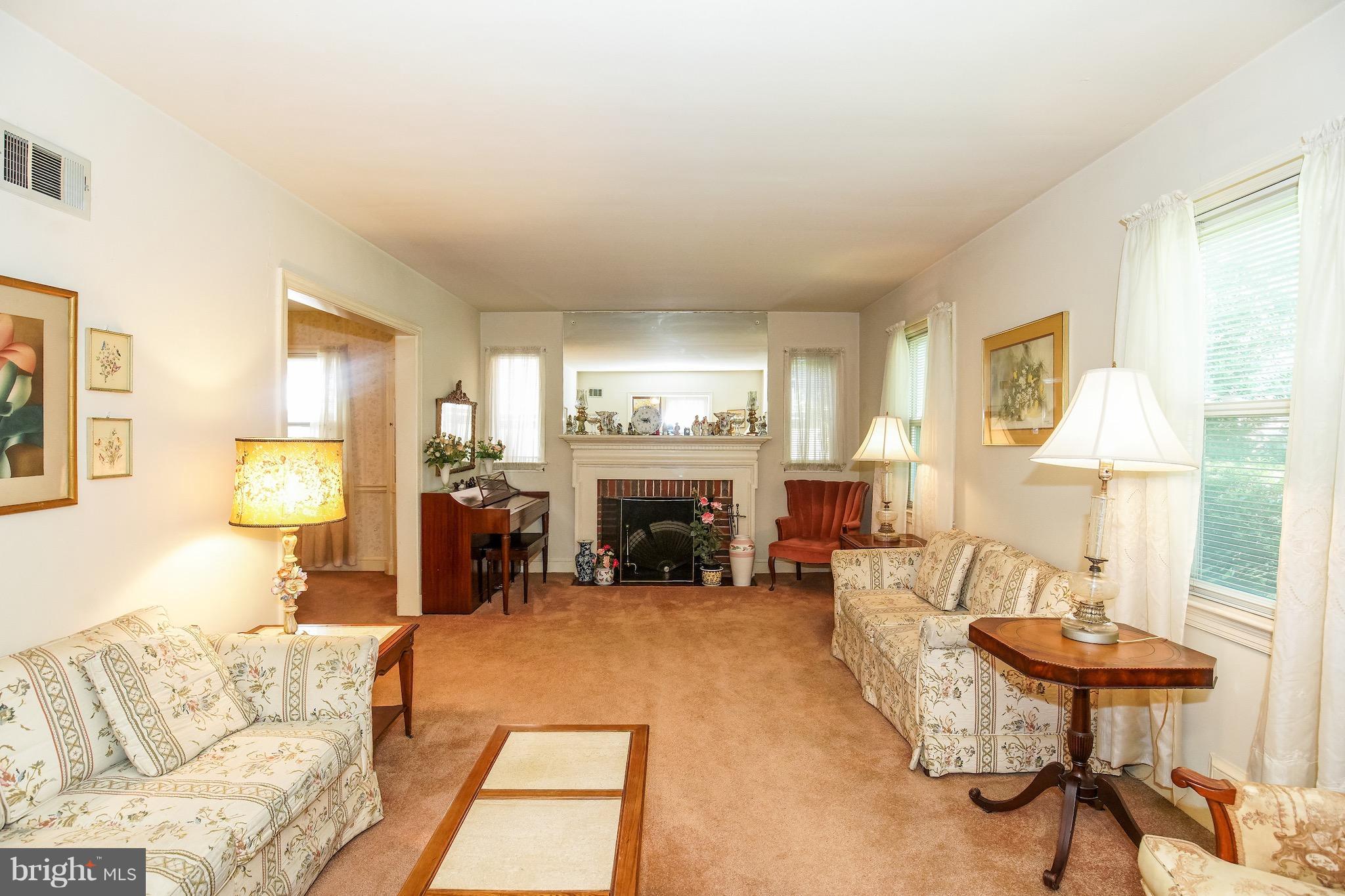 4334 Reno Road Northwest Washington, DC 20008 - Photo 2 of 16 a living room with furniture and a fireplace