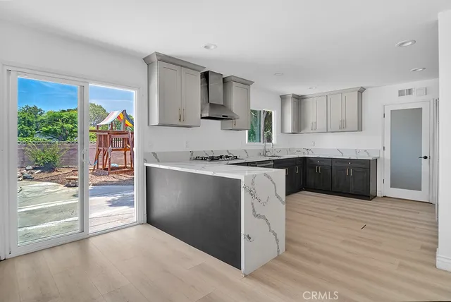 a kitchen with stainless steel appliances granite countertop a stove a sink and a refrigerator