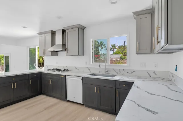a kitchen with a sink stove and cabinets