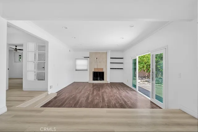 wooden floor in an empty room with a fireplace