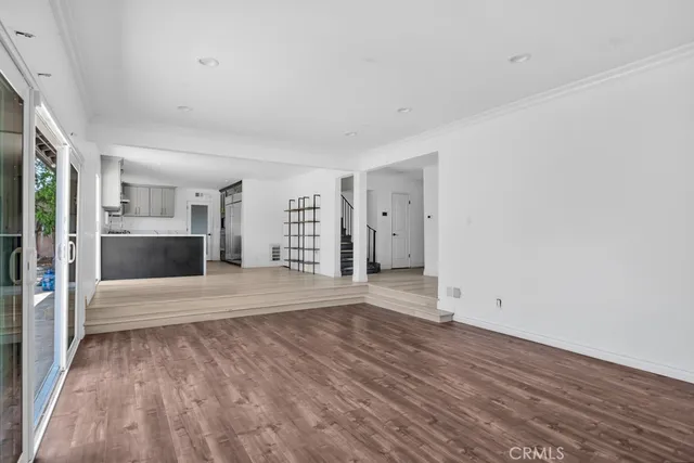 a view of a kitchen with a sink and a refrigerator
