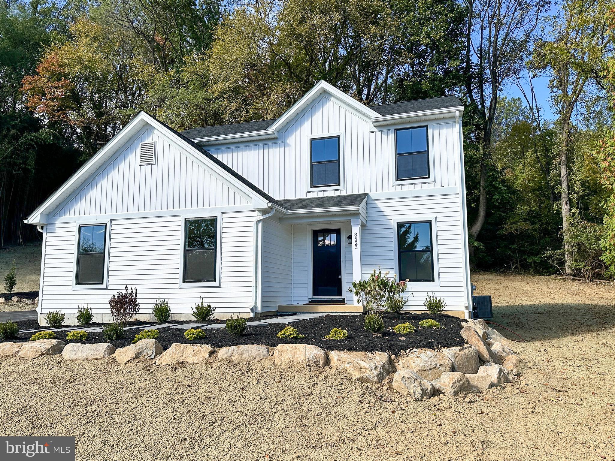 3523 Humpton Road Downingtown, PA 19335 - Photo 2 of 55 a front view of house with yard and trees around