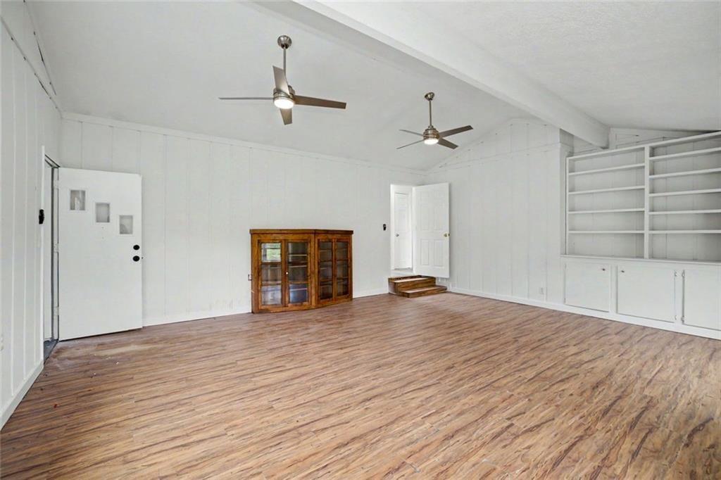 1605 Shackelford Road Griffin, GA 30224 - Photo 20 of 51 an empty room with wooden floor and ceiling fan