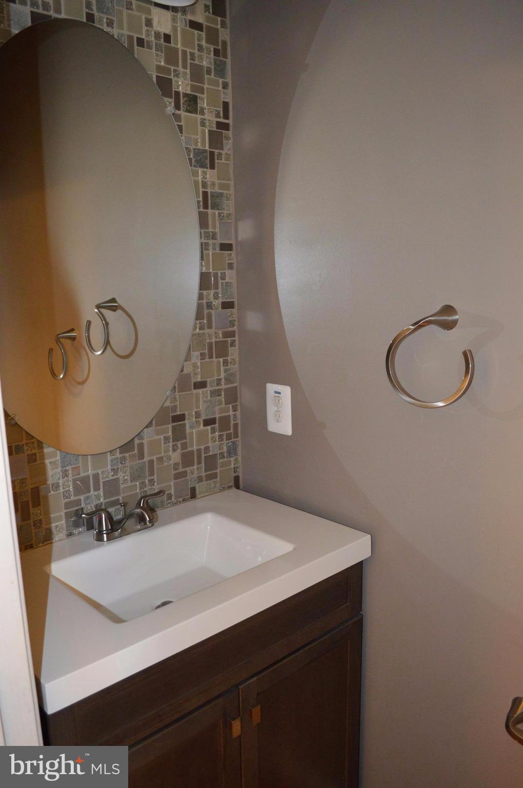 6500 Clarington Road Baltimore, MD 21209 - Photo 13 of 30 a bathroom with a sink and a mirror