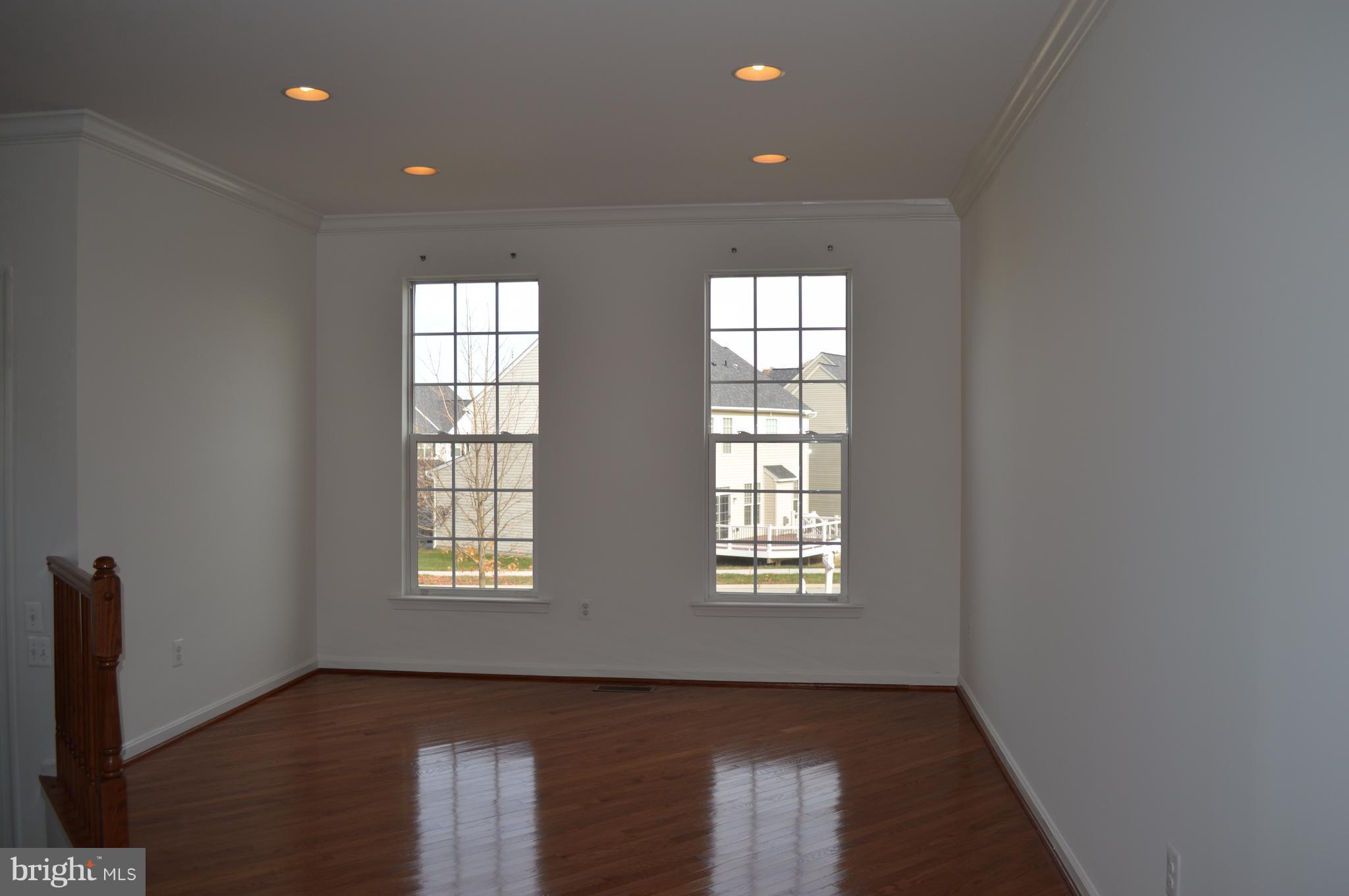 6500 Clarington Road Baltimore, MD 21209 - Photo 3 of 30 an empty room with wooden floor and windows