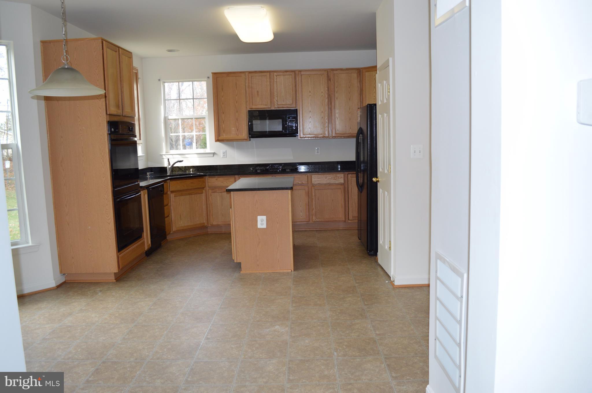 6500 Clarington Road Baltimore, MD 21209 - Photo 5 of 30 a kitchen with stainless steel appliances a refrigerator and a stove