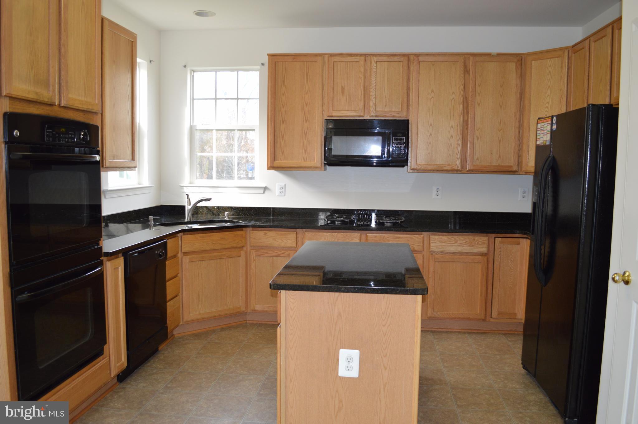 6500 Clarington Road Baltimore, MD 21209 - Photo 6 of 30 a kitchen with a refrigerator and a sink