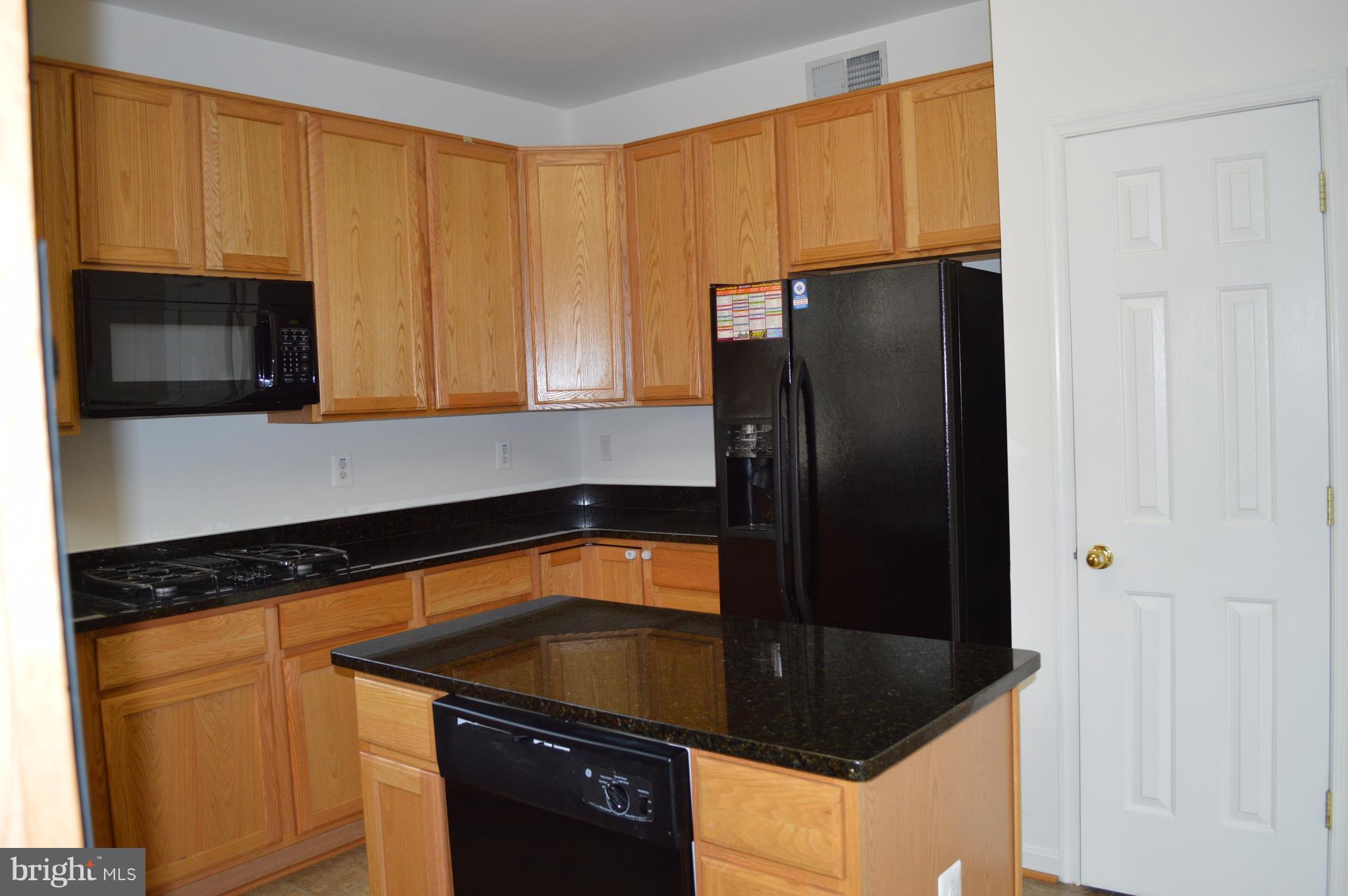 6500 Clarington Road Baltimore, MD 21209 - Photo 8 of 30 a kitchen with granite countertop stainless steel appliances a refrigerator and a sink